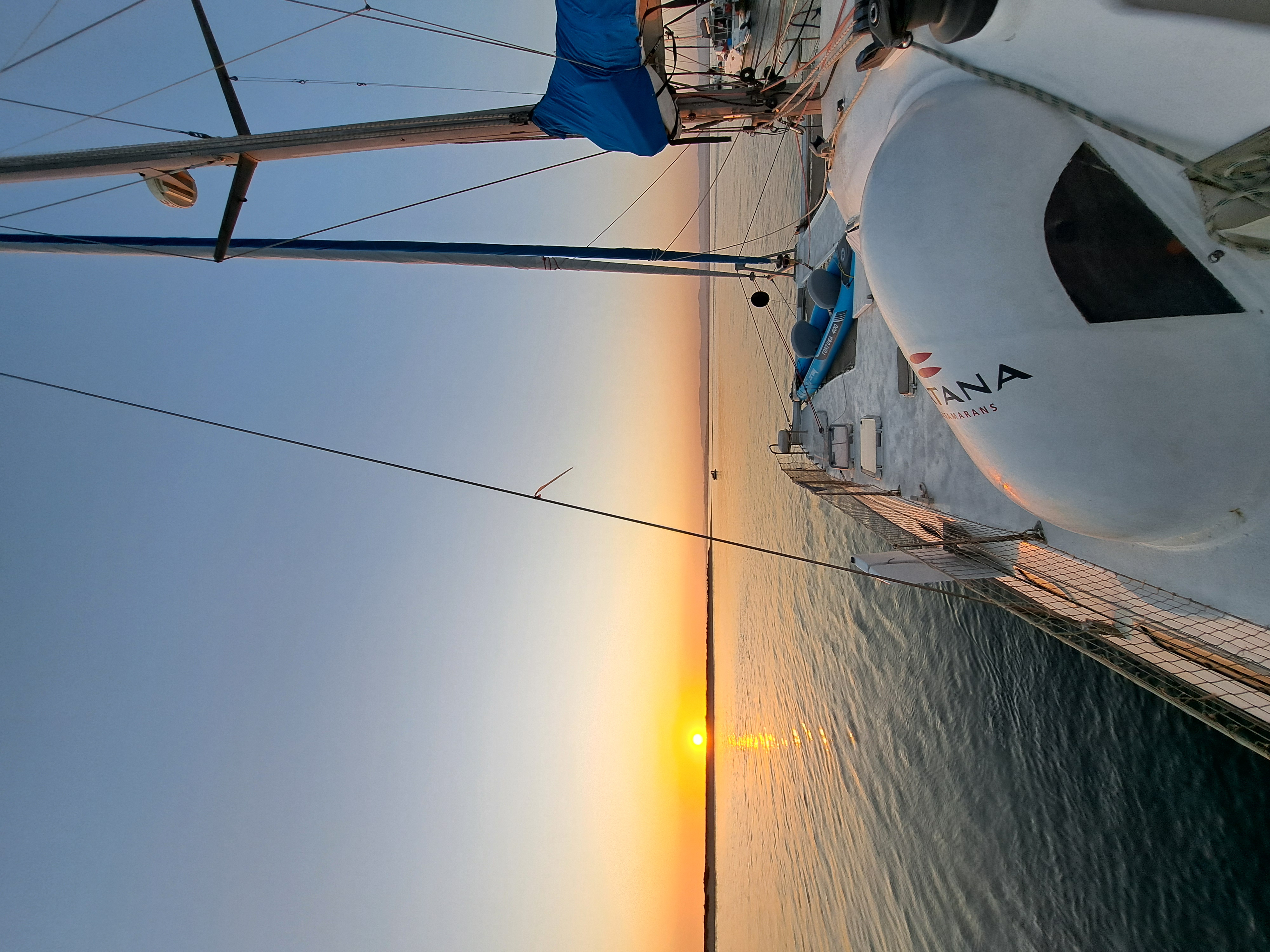 Stunning sunset view from the deck of a CATANA catamaran at sea